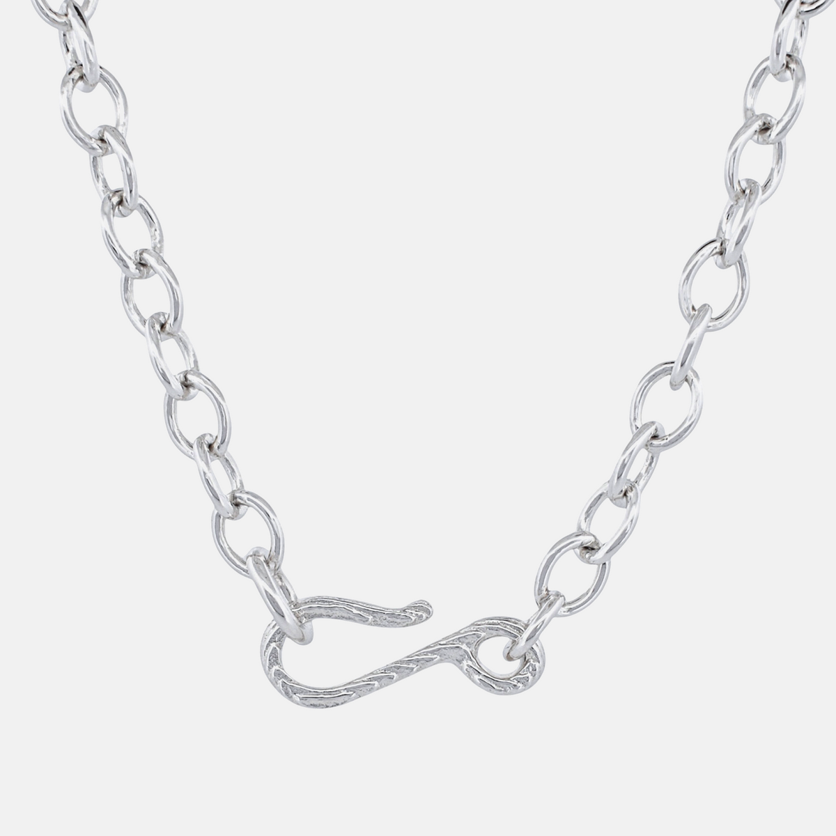 A silver chain necklace featuring a unique twisted infinity symbol clasp, shown against a light gray background.