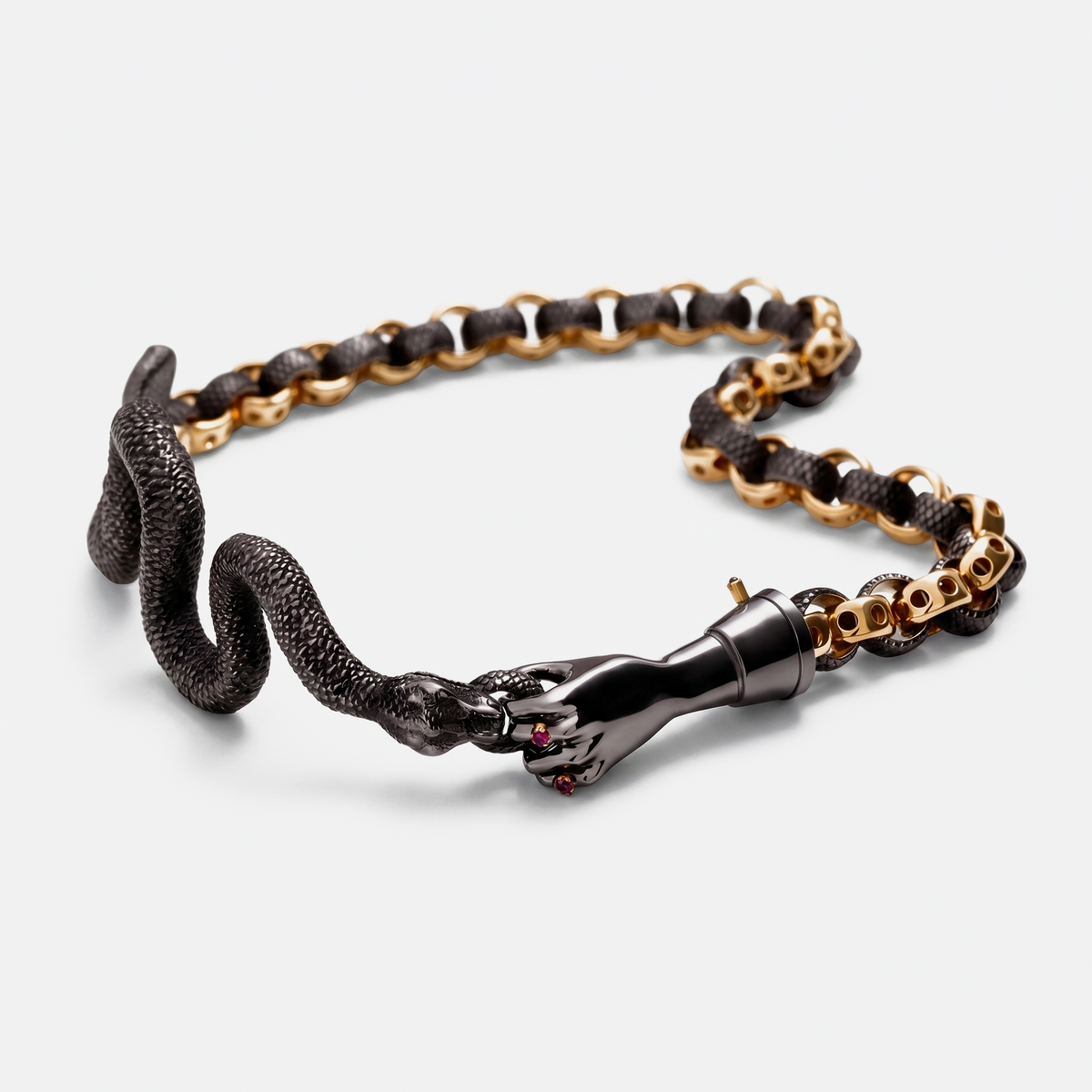 Gold and black snake chain bracelet with sculptural hand clasp, contemporary jewellery