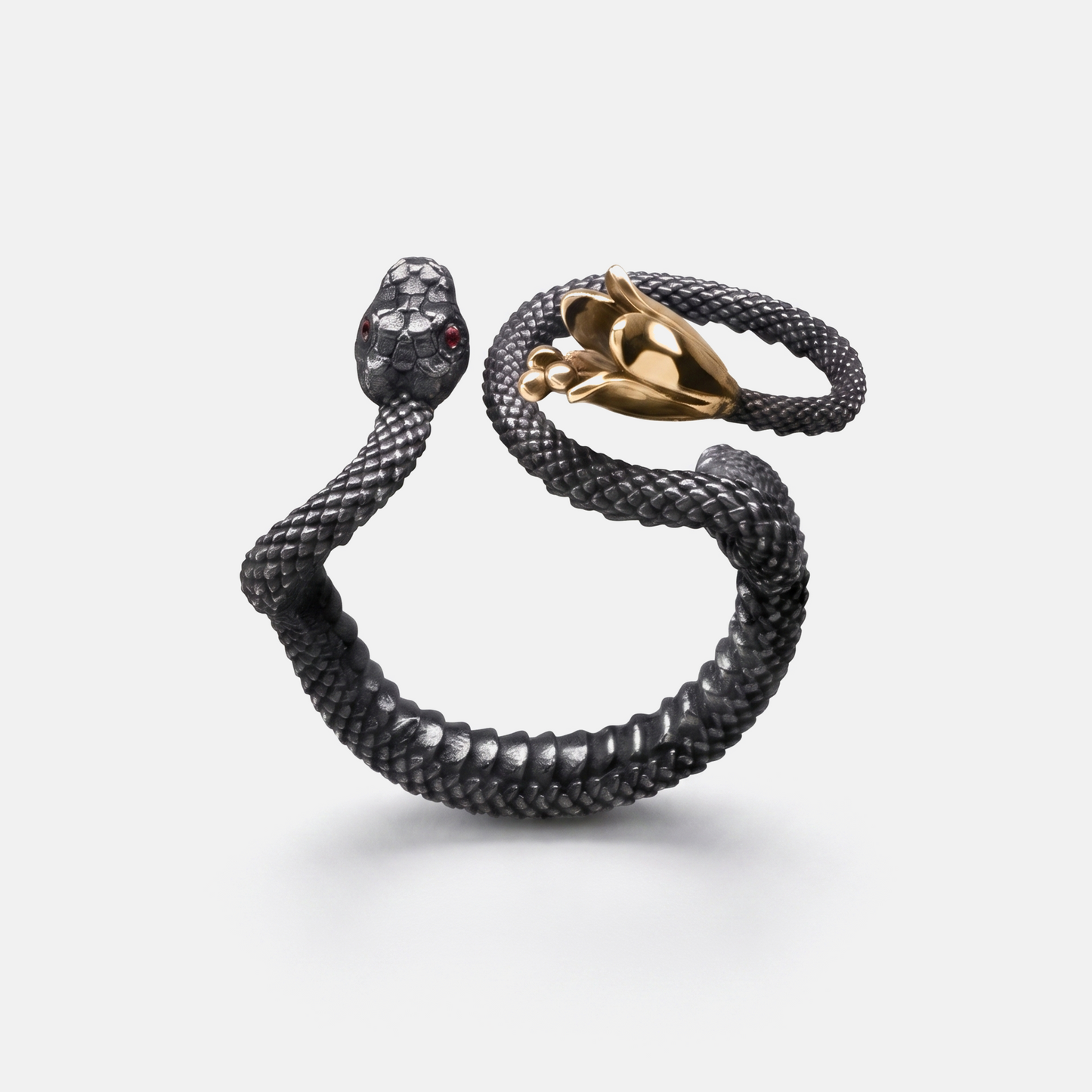 Black snake wrap ring with gold hand detail, statement jewellery piece on white background