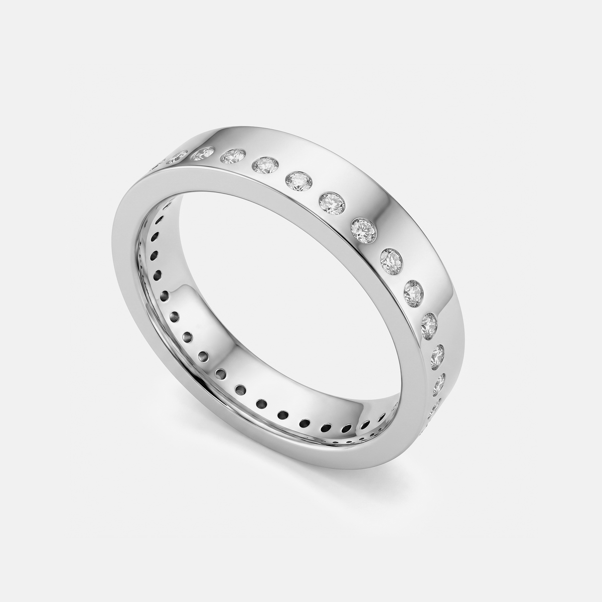 A polished silver-toned eternity ring with a row of small clear gemstones set along the outer band, shown on a light gray background.