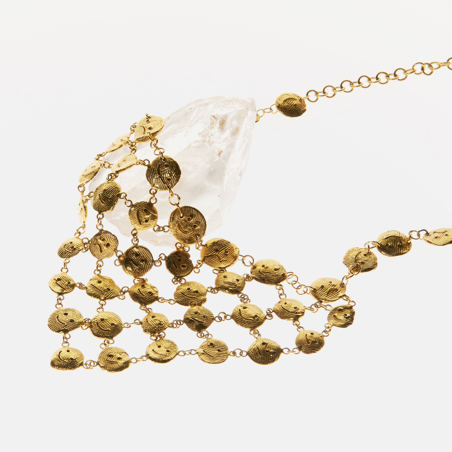 Textured gold sculptural necklace with abstract face elements