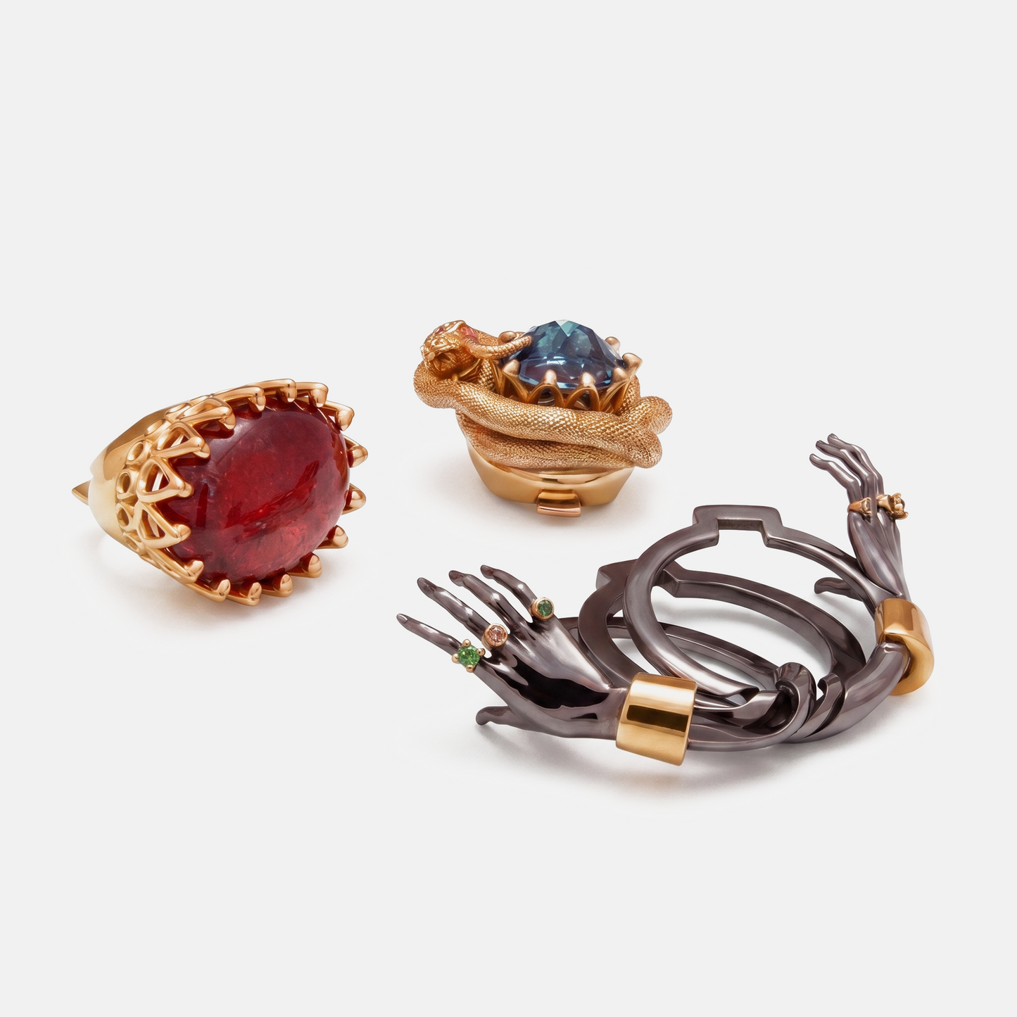 Set of luxury designer rings with red and blue gemstones, sculptural hand jewellery in gold, statement collection