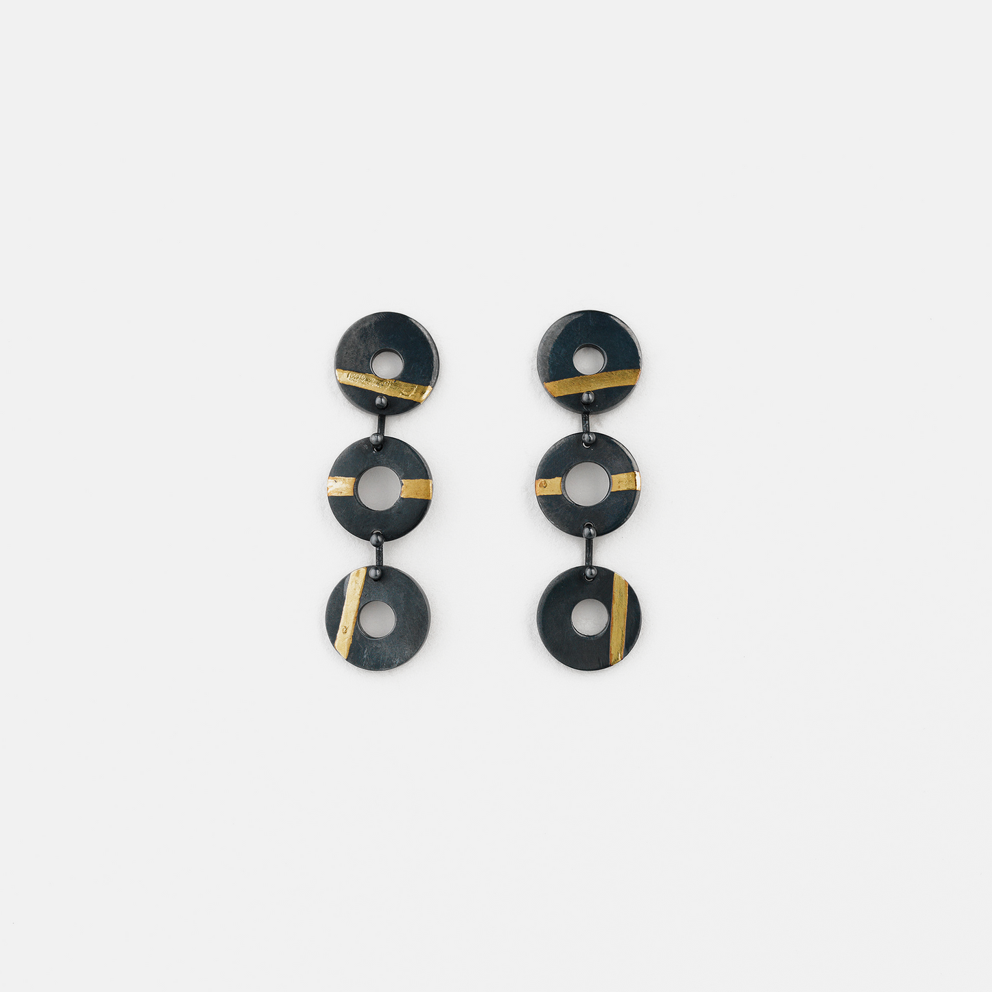Chronos Trio oxidised sterling silver drop earrings featuring three articulated torus links with 24ct gold keum-boo detailing.