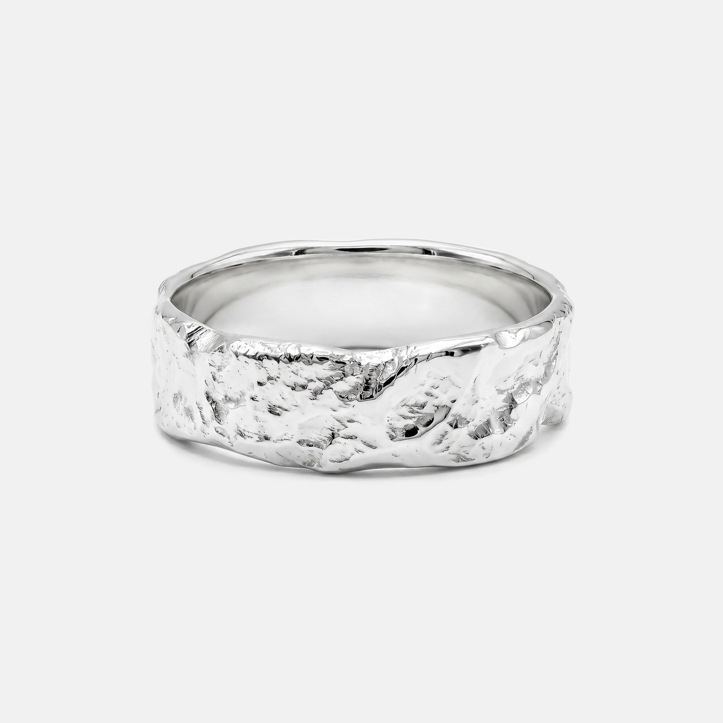 Silver ring with a textured band on a light gray background