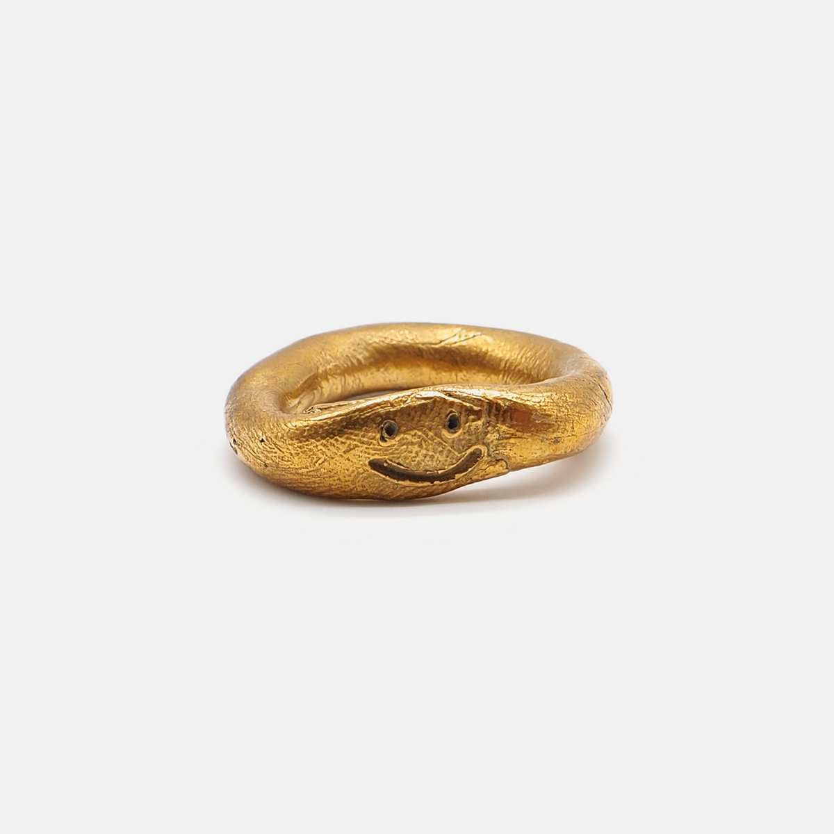 Gold ring shaped like a snake on a white background