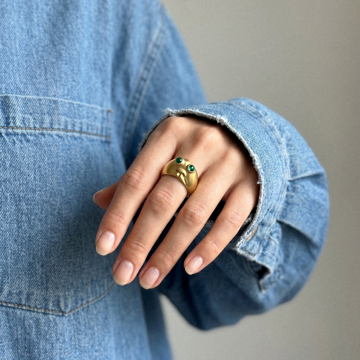 Model wearing Baby’s Got Green Eyes emerald ring in 18k gold by Charlotte Le Hardy
