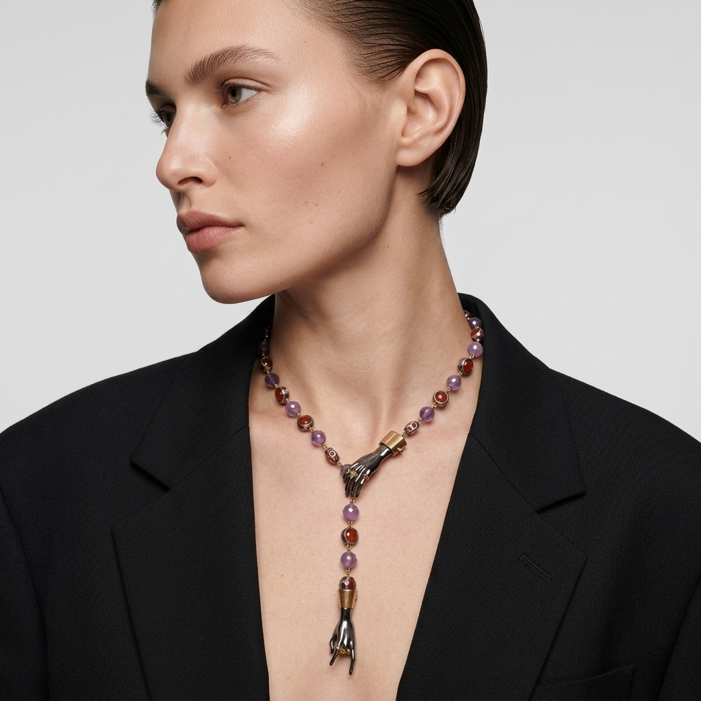 Model wearing artistic statement necklace with hand pendants and gemstones, luxury designer jewellery, modern elegant look for women