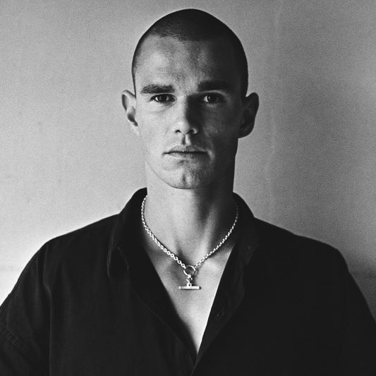 Man wearing a contemporary sterling silver chain necklace and pendant, modern men's jewellery style