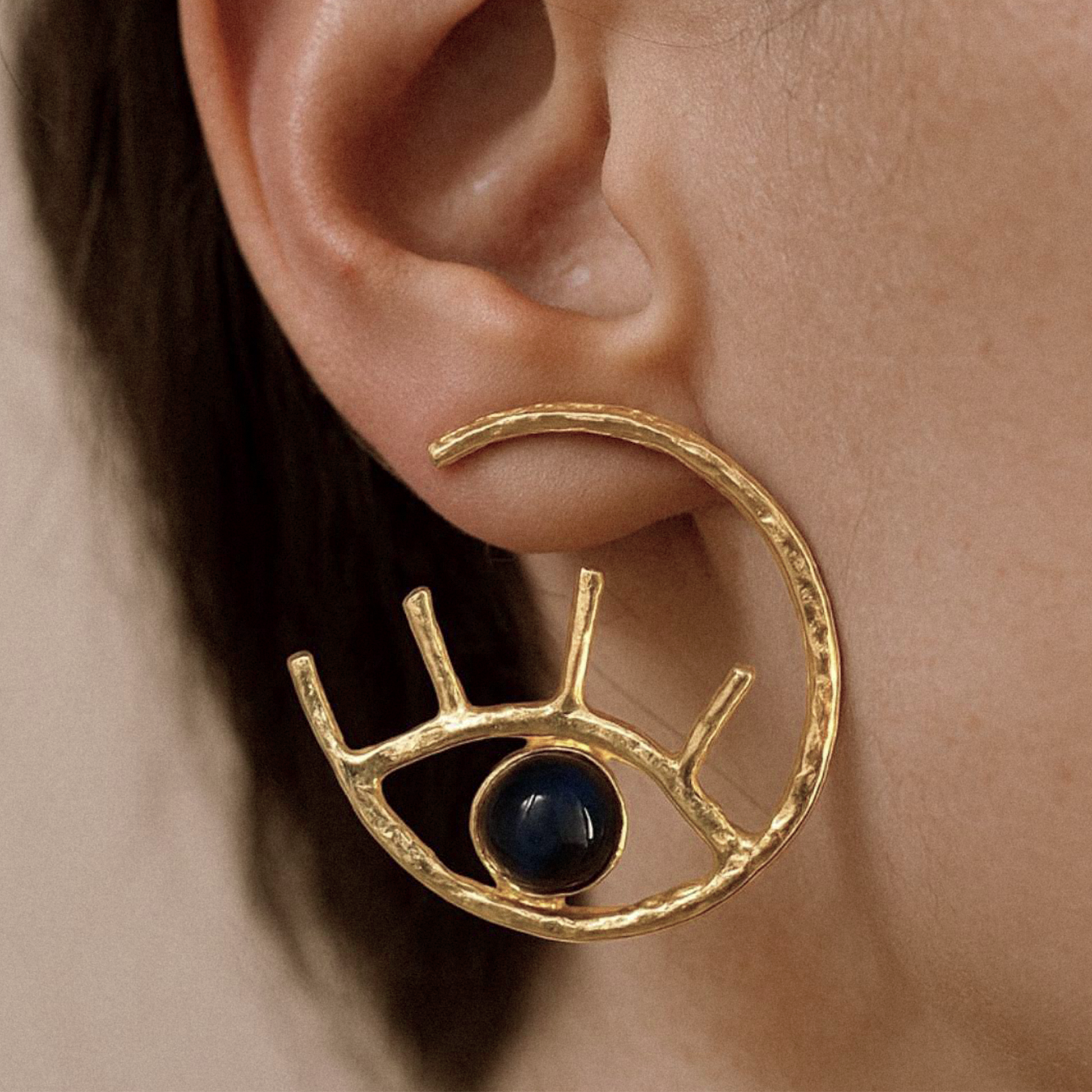 Model wearing sodalite gold hoop earrings