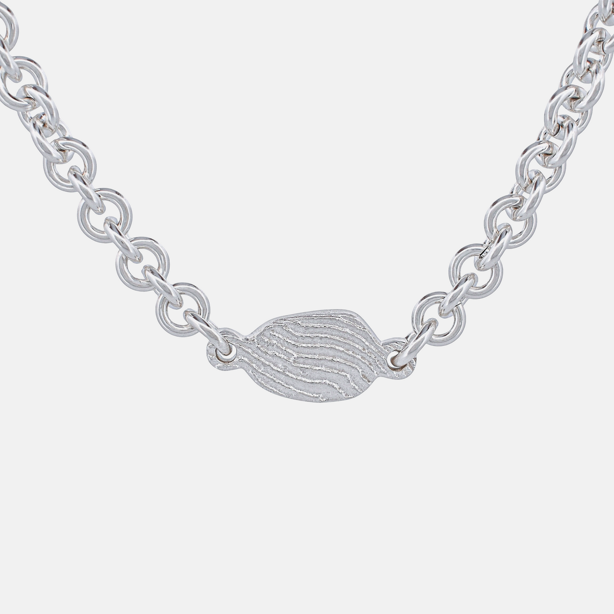 Silver chain necklace with a small, detailed pendant on a white background