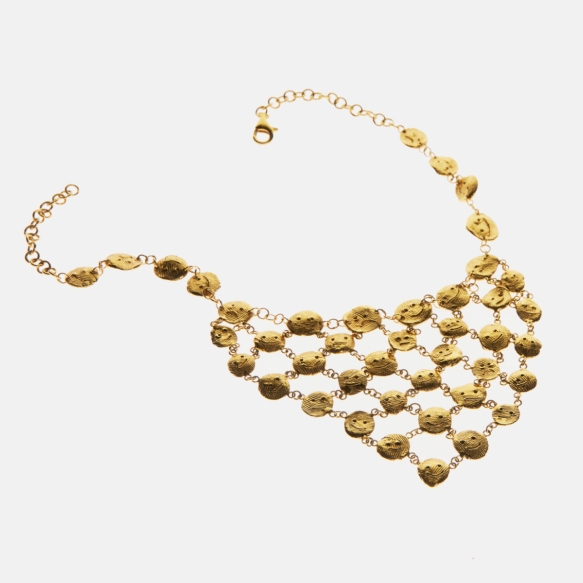 Handcrafted gold statement necklace with sculptural face details