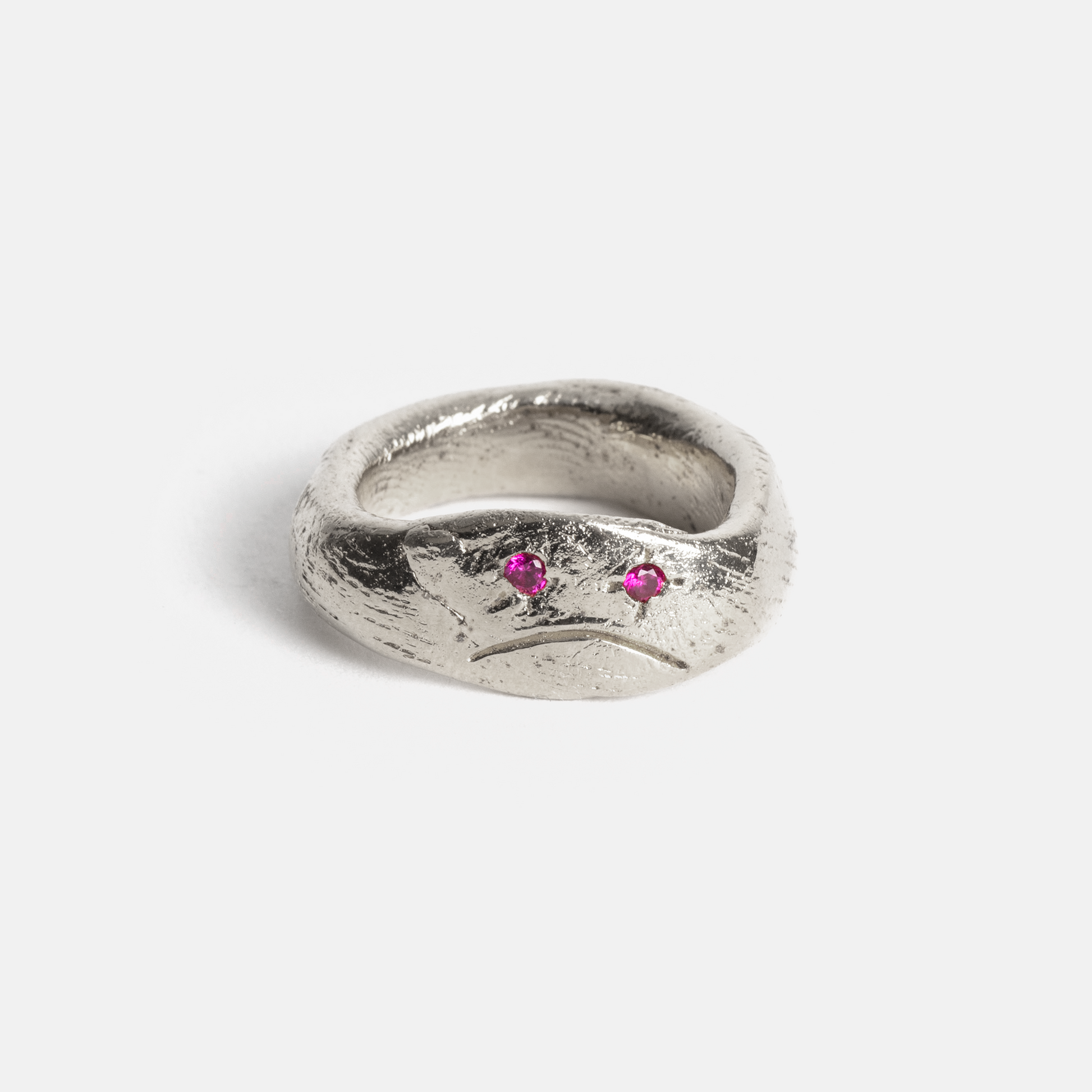 Silver ring with two pink stones on a white background