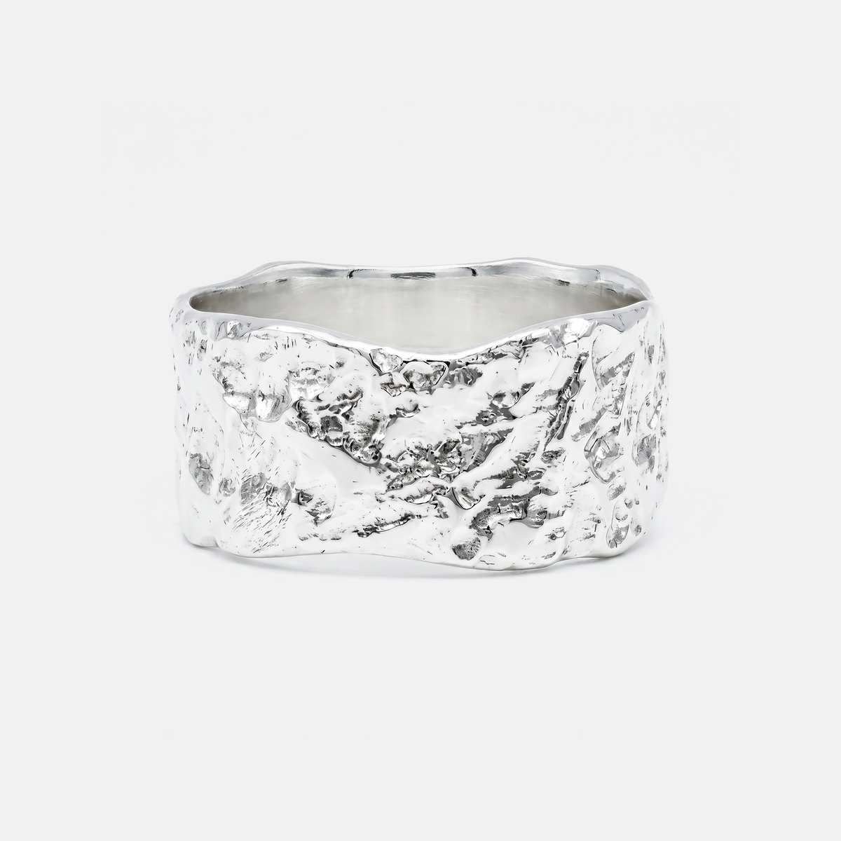 Silver ring with a textured surface on a white background
