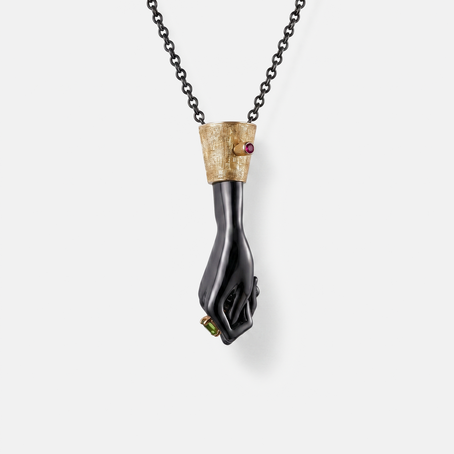 Black gold hand pendant necklace with ruby and green gemstone, designer statement jewellery, luxury unique pendant