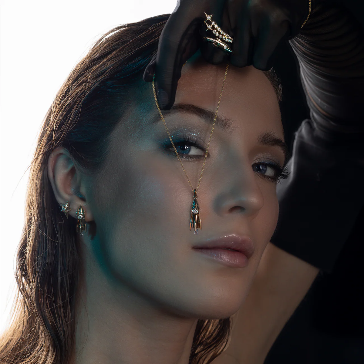 Gold rocket pendant necklace with diamond worn on model, luxury celestial fine jewellery styling