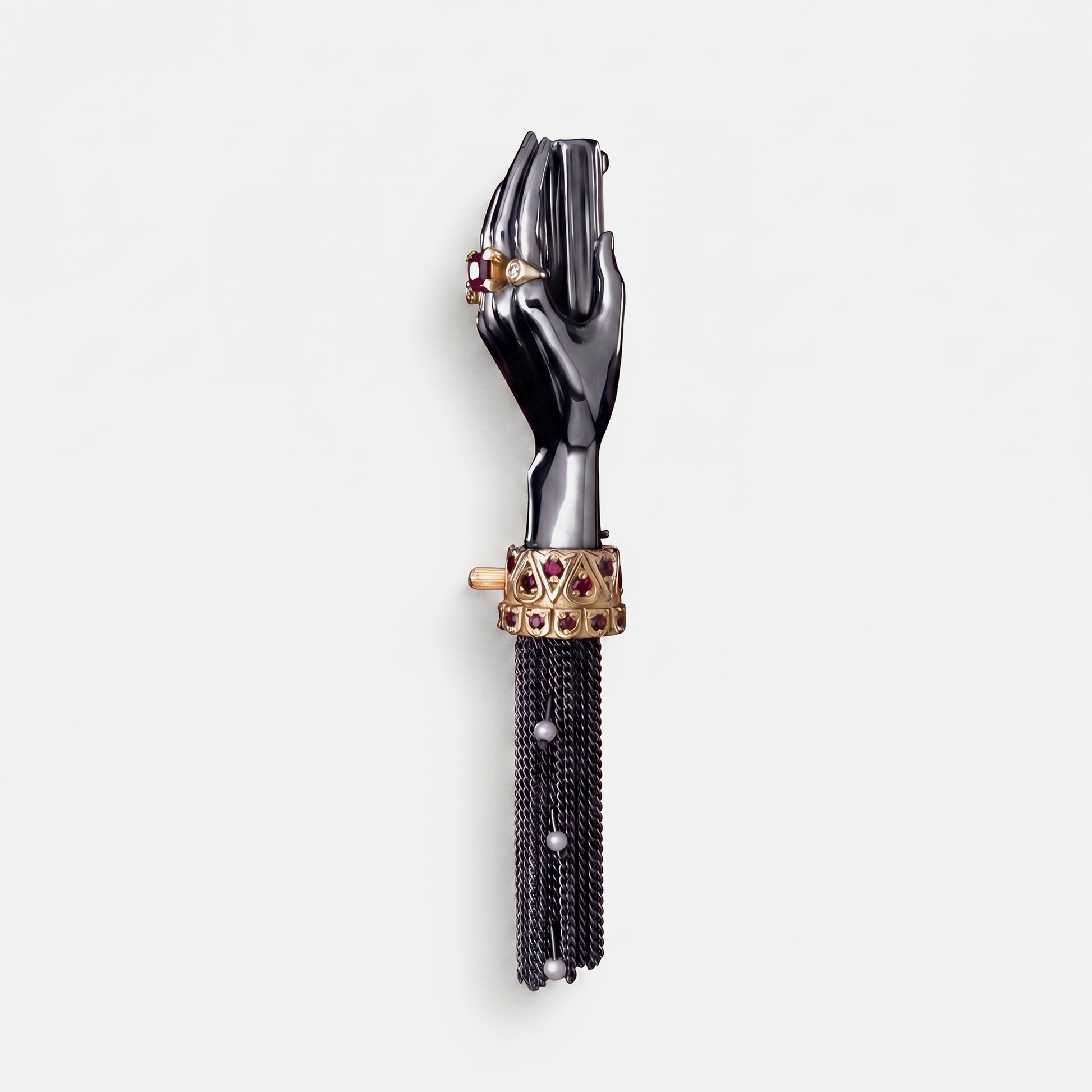 Black hand brooch with gold cuff, ruby stones and chain tassel, unique designer jewellery piece