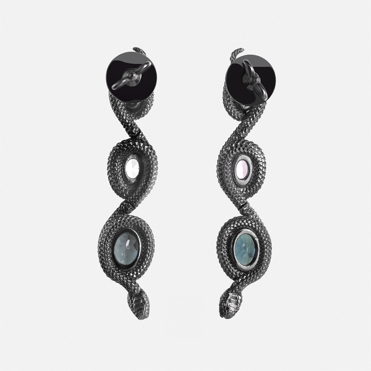 Back view of snake-shaped drop earrings with gemstone settings, sculptural designer jewellery piece