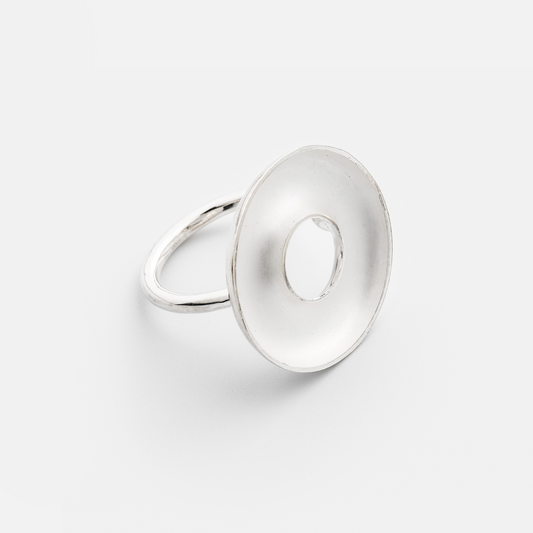 Silver ring with a unique design on a light gray background