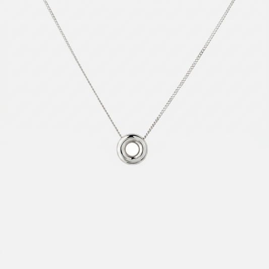 Handmade Monad Mini Sterling Silver Necklace featuring a polished 10 mm torus pendant on a fine sterling silver curb chain. Contemporary minimalist jewellery handcrafted in Glasgow.