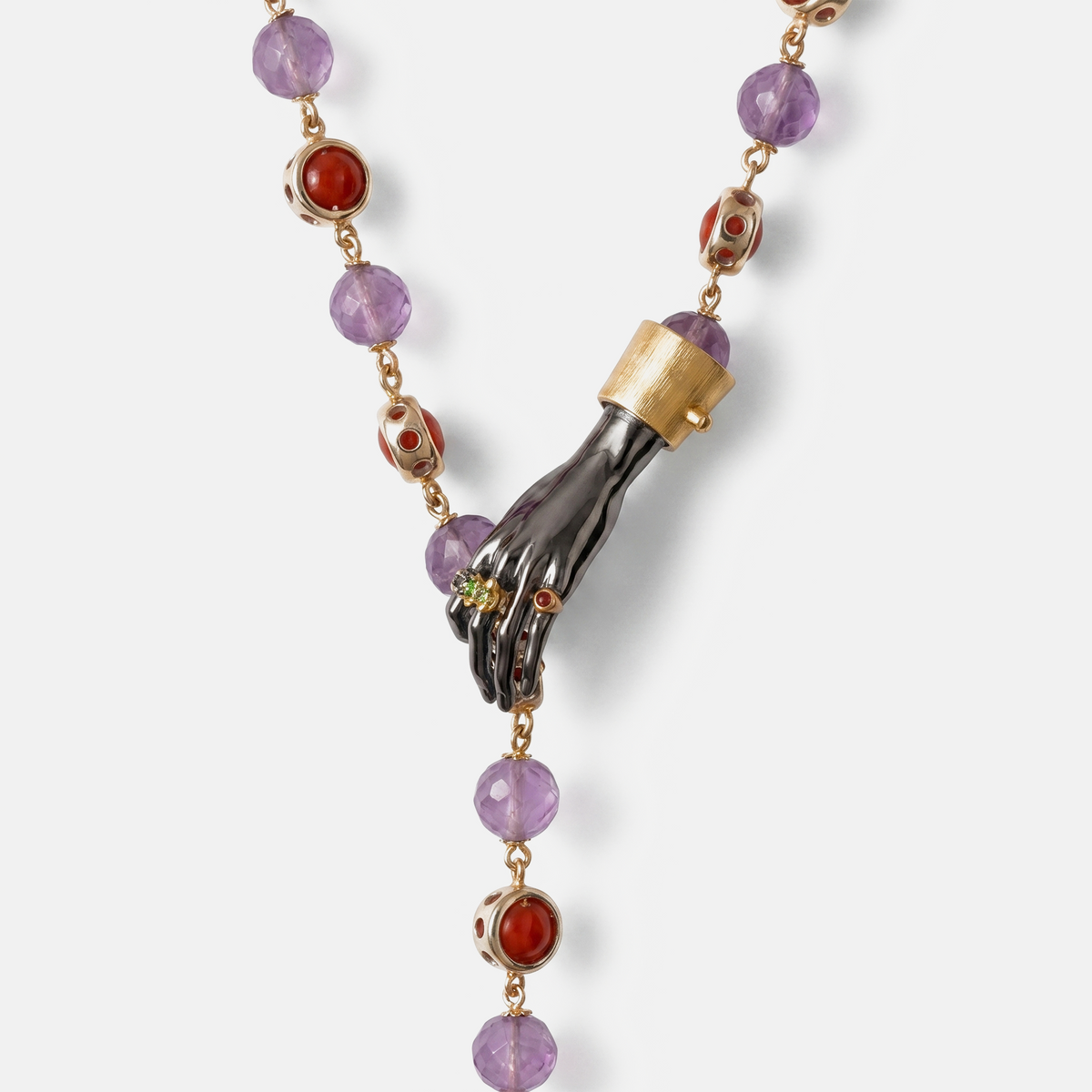Close-up of sculptural hand pendant with gemstones on luxury necklace, amethyst and red stones, artistic fine jewellery detail, high-end designer piece