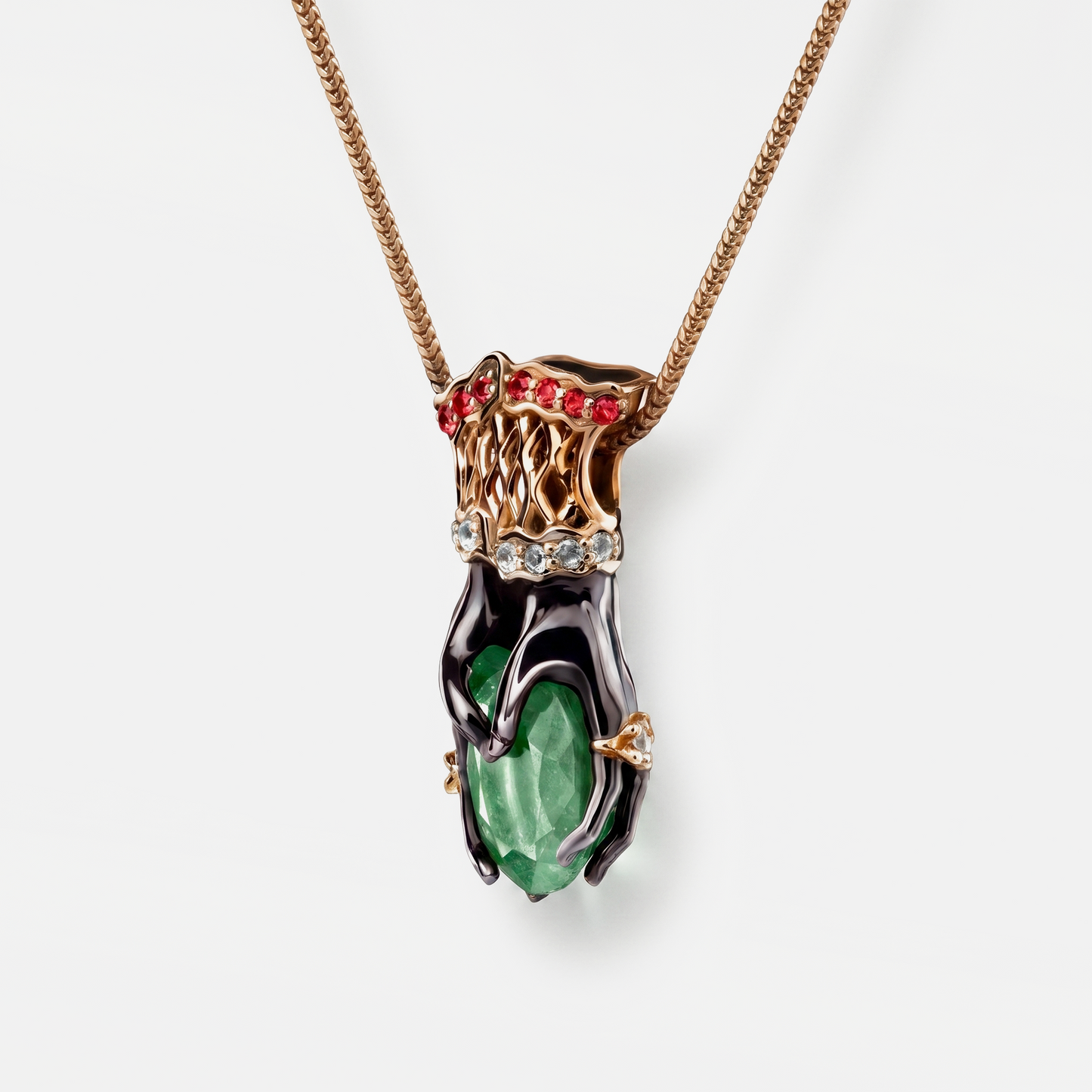 Luxury pendant necklace with green gemstone and red stones on a white background
