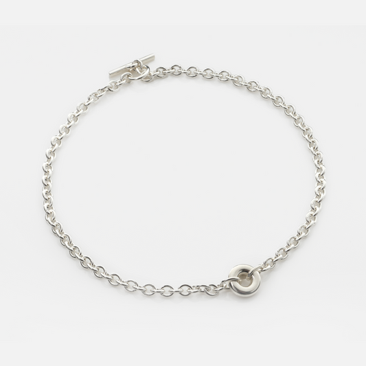Handmade sterling silver Monad Chain Necklace featuring a polished sculptural torus pendant, chunky cable chain and T-bar clasp. Contemporary designer jewellery handcrafted in Glasgow.