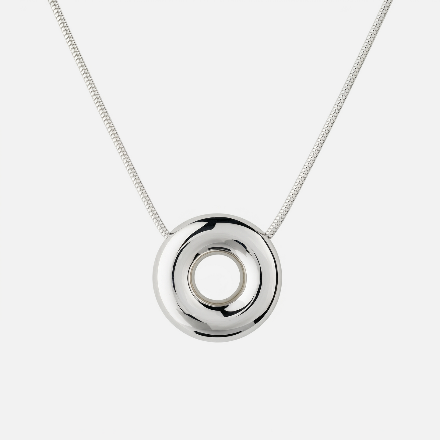 Handmade Statement Monad Sterling Silver Necklace featuring a polished sculptural torus pendant on a sterling silver snake chain with chunky hook clasp.