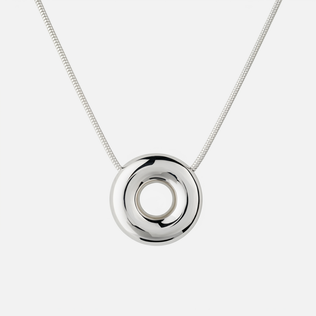 Handmade Statement Monad Sterling Silver Necklace featuring a polished sculptural torus pendant on a sterling silver snake chain with chunky hook clasp.