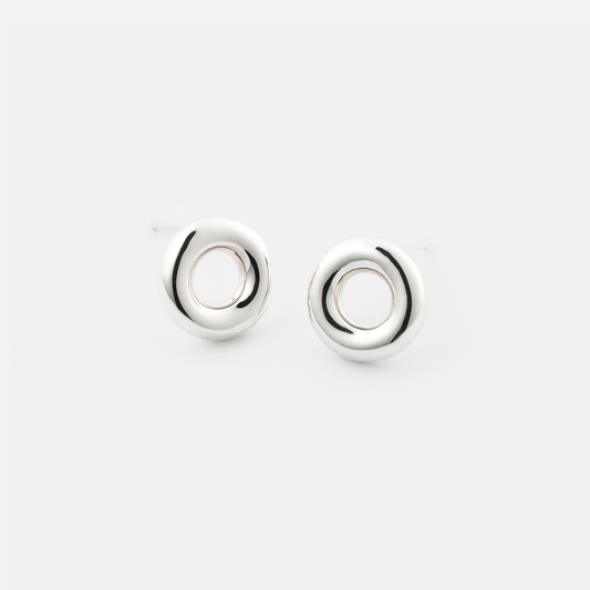 Pair of silver circular earrings on a white background