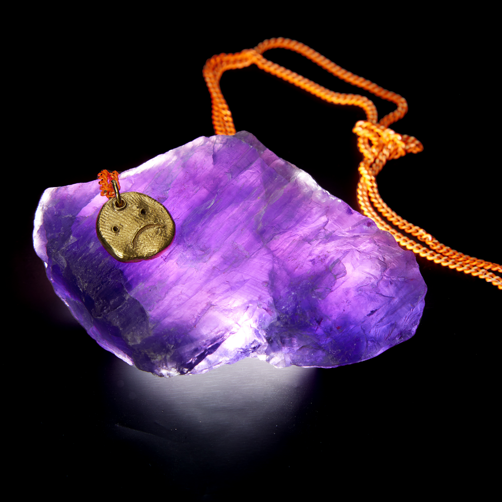Contemporary gold pendant necklace with neon orange chain