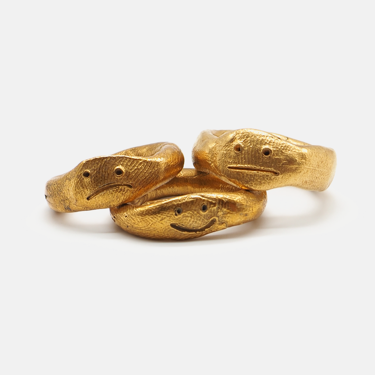 Gold snake-shaped ring on a white background