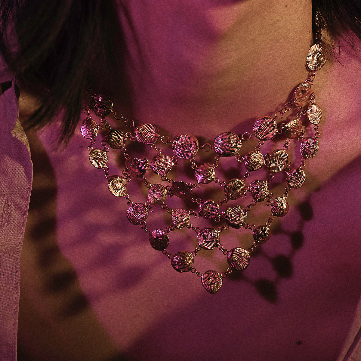 Layered gold statement necklace worn on model