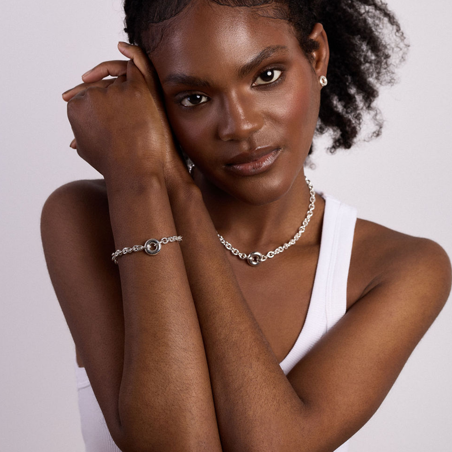 Model wearing the handcrafted Monad Sterling Silver Chain Necklace featuring a sculptural torus pendant and contemporary sterling silver chain.