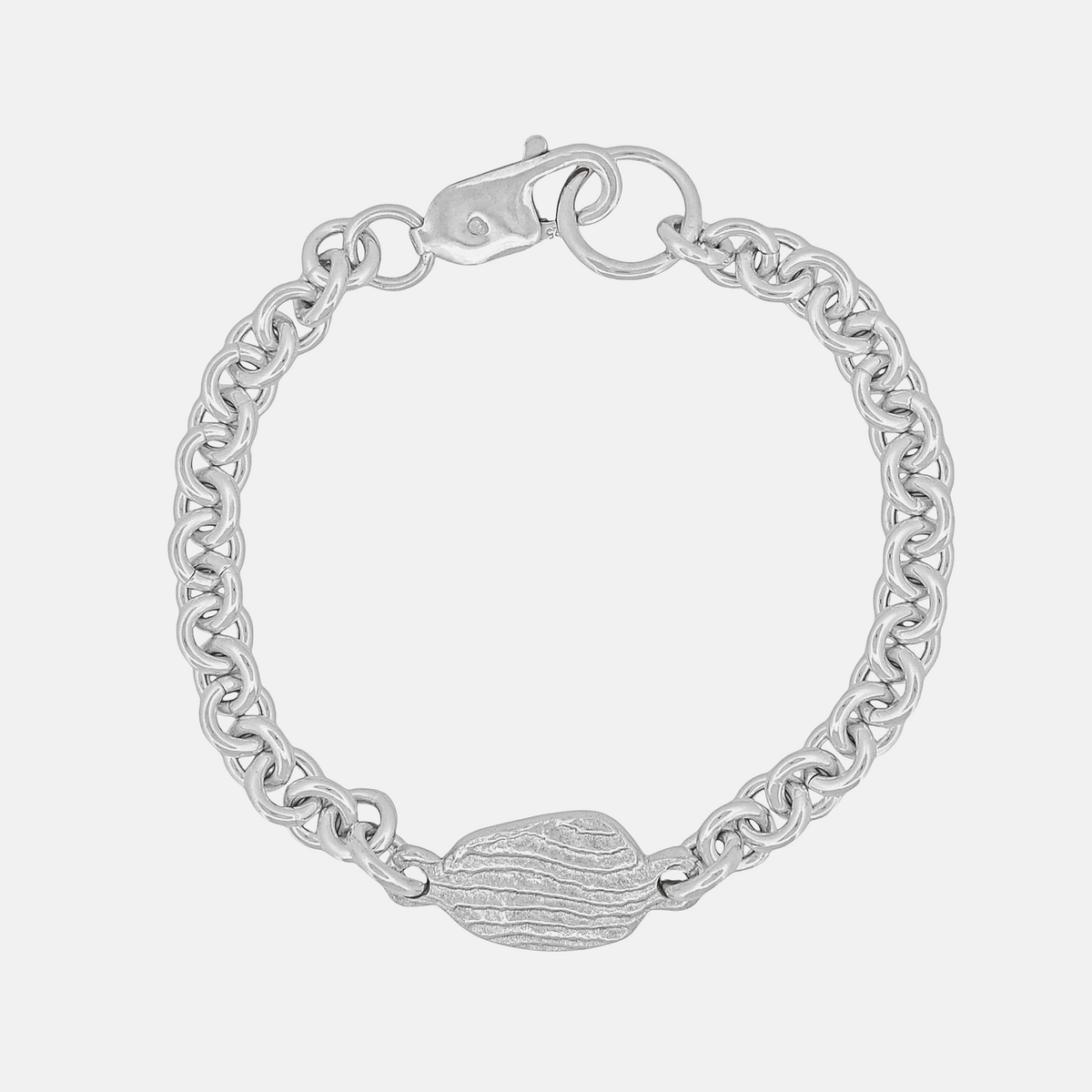 A silver chain bracelet with a textured oval center charm and a spring-ring clasp, shown on a light gray background.
