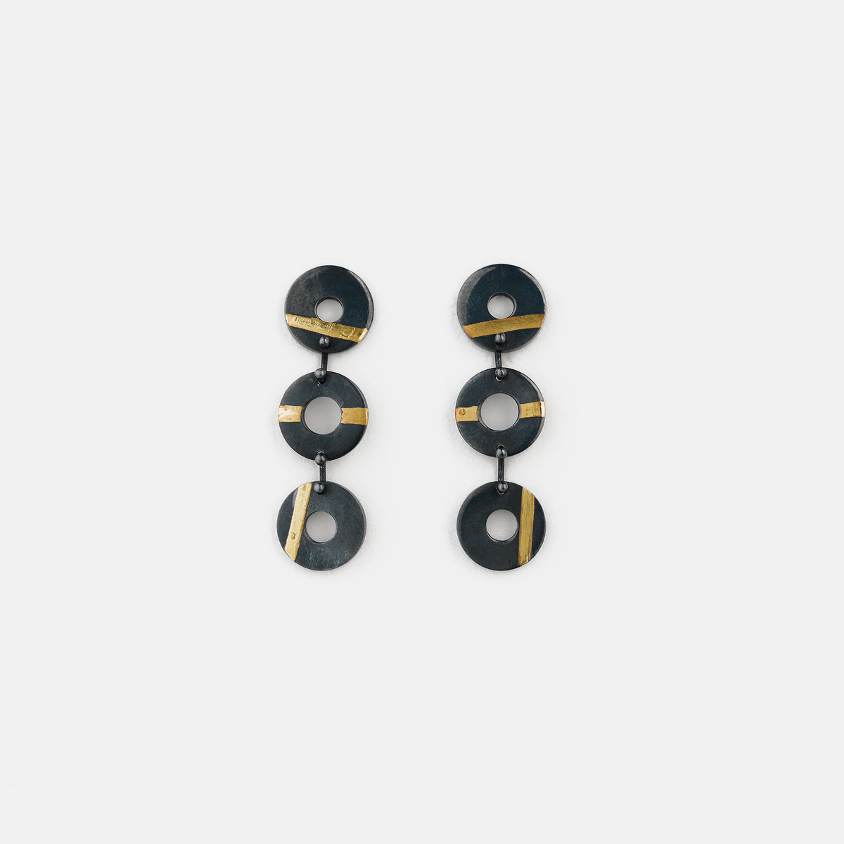 Chronos Trio oxidised sterling silver drop earrings featuring three articulated torus links with 24ct gold keum-boo detailing.