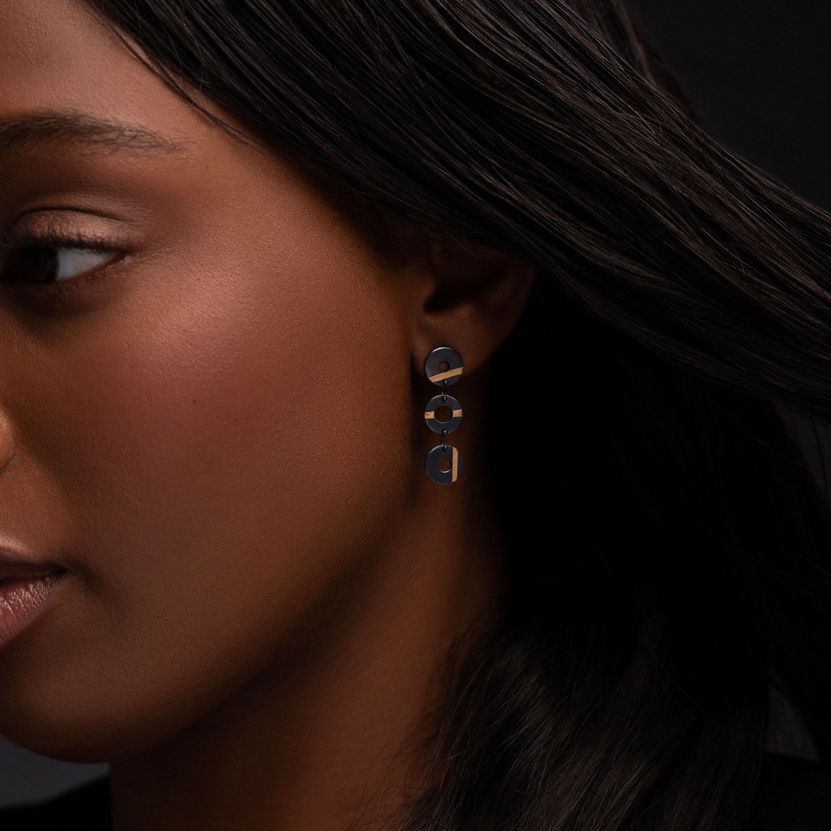 Chronos Trio oxidised sterling silver drop earrings featuring three articulated torus links with 24ct gold keum-boo detailing.