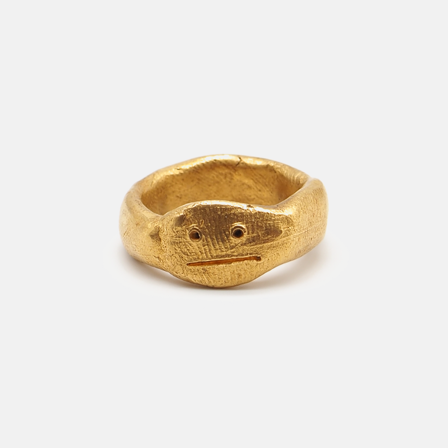 Gold ring with a textured design on a white background