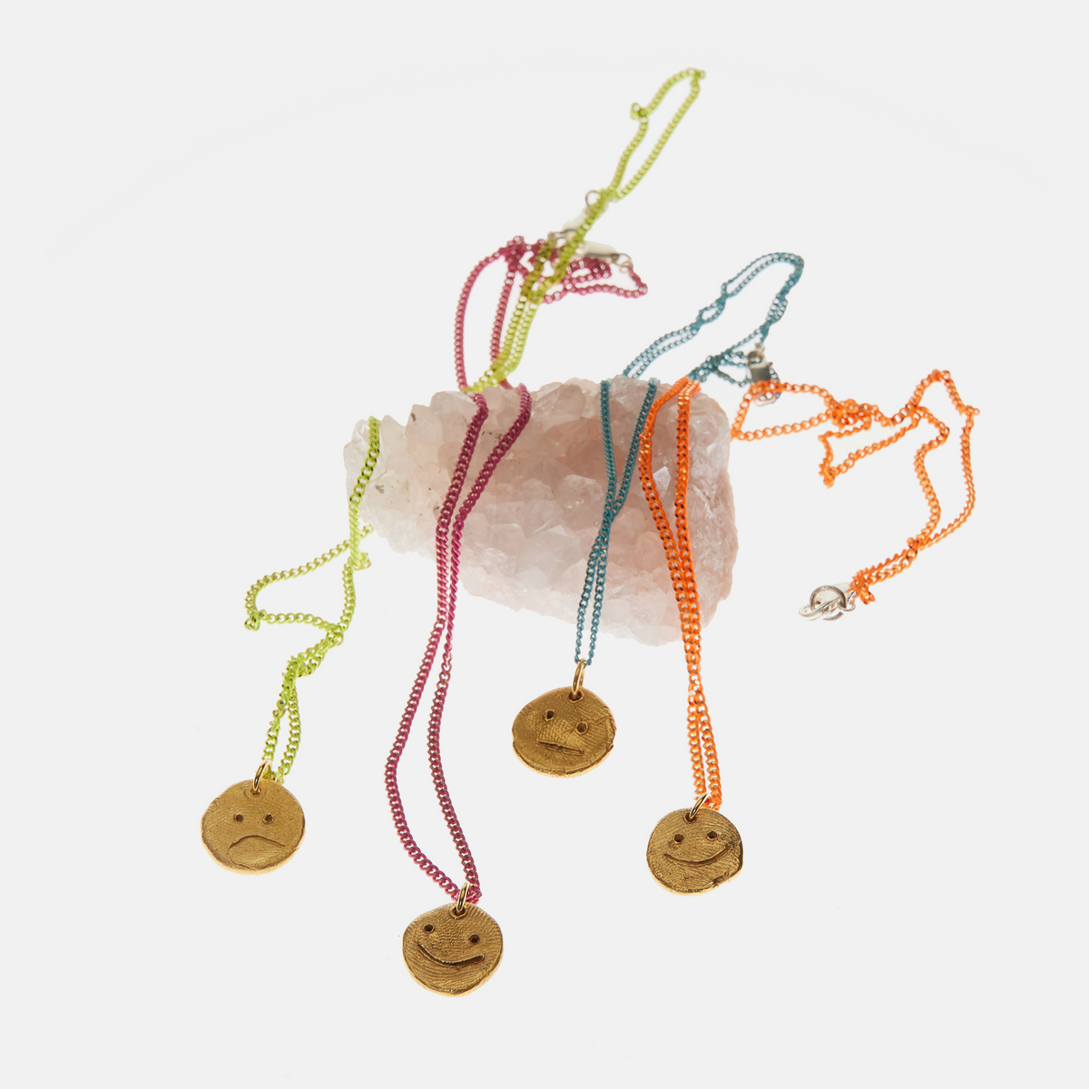 Colourful artisan pendant necklaces styled with natural crystal