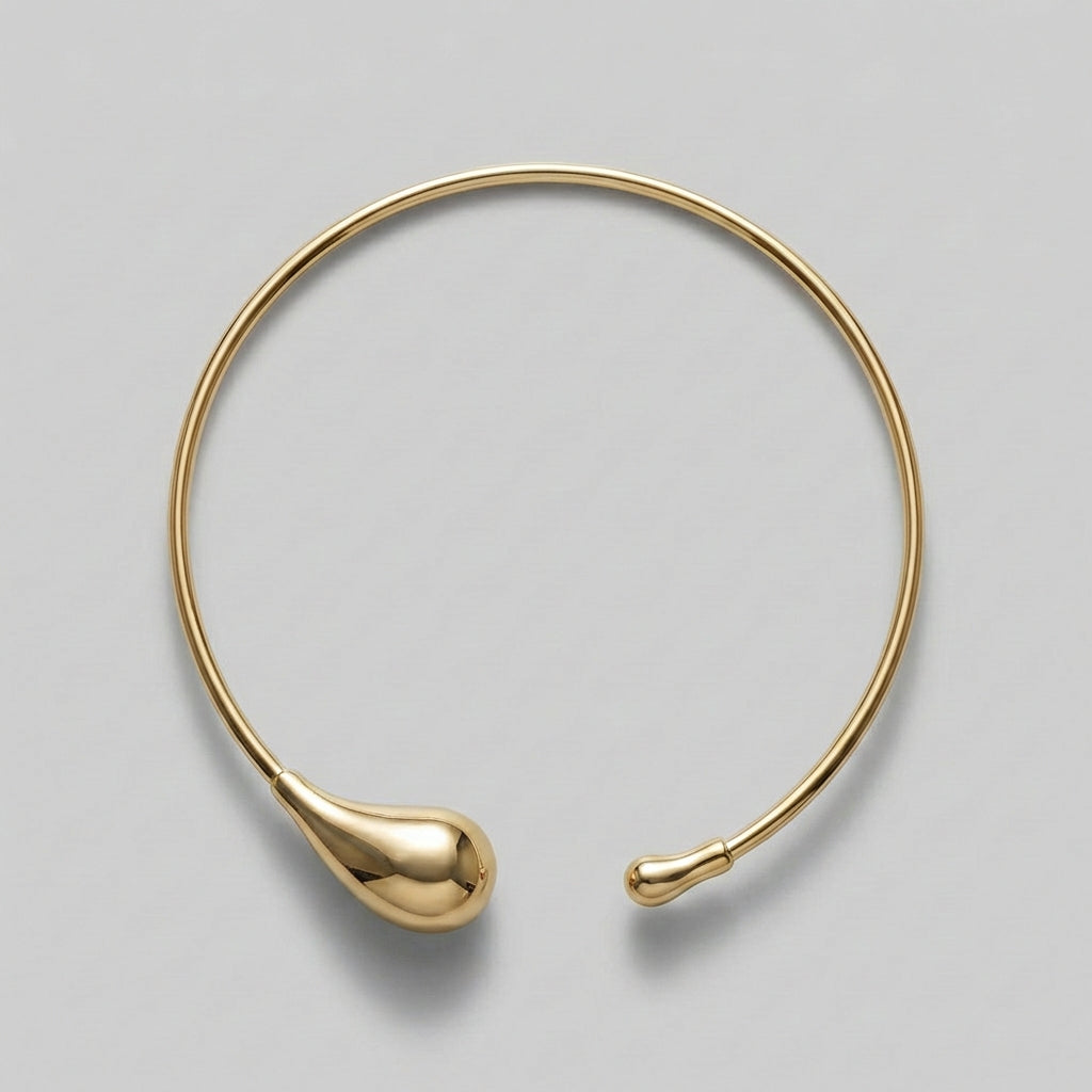 Gold necklace on a gray background
