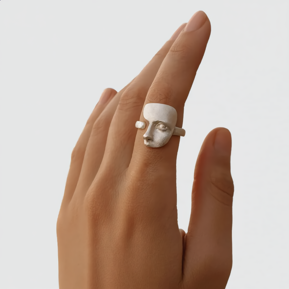 hand wearing silver face statement ring bold contemporary jewellery for women