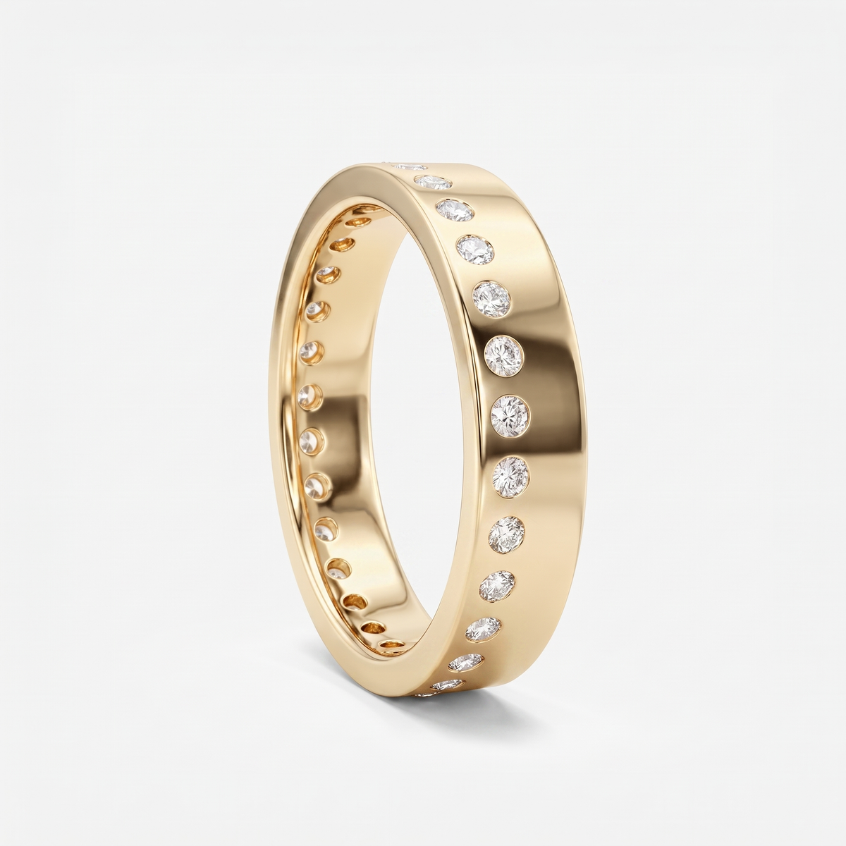 A polished yellow gold eternity-style ring with a row of round clear gemstones set around the band, shown on a clean light gray background.