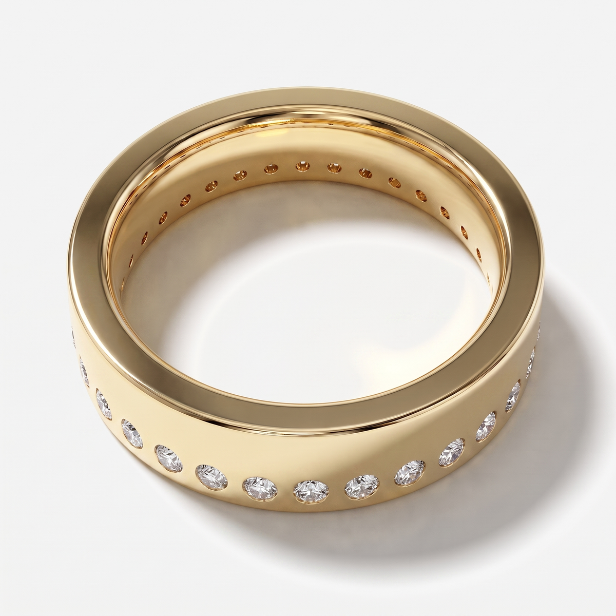 A polished yellow gold eternity-style ring with a continuous row of round clear gemstones set around the band, photographed on a clean white background.